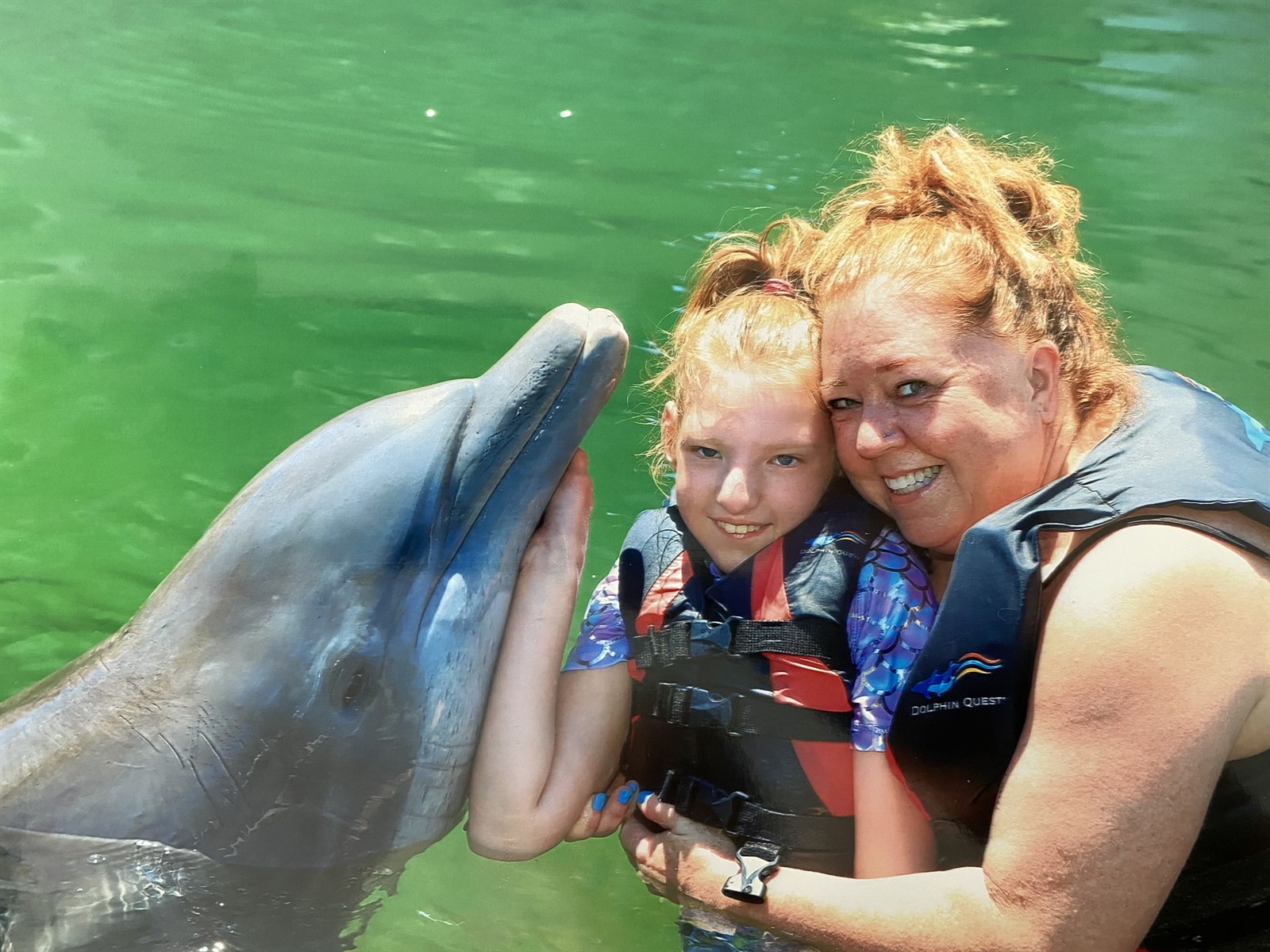 Stephanie and Stella with a dolphin, the inspiration behind Starbound Luxe Co.